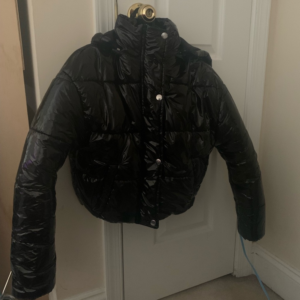 Jacket comes in a petite size (2). Brand new with tags, this jacket is hooded.